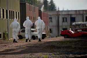 3 men in hazmat suits